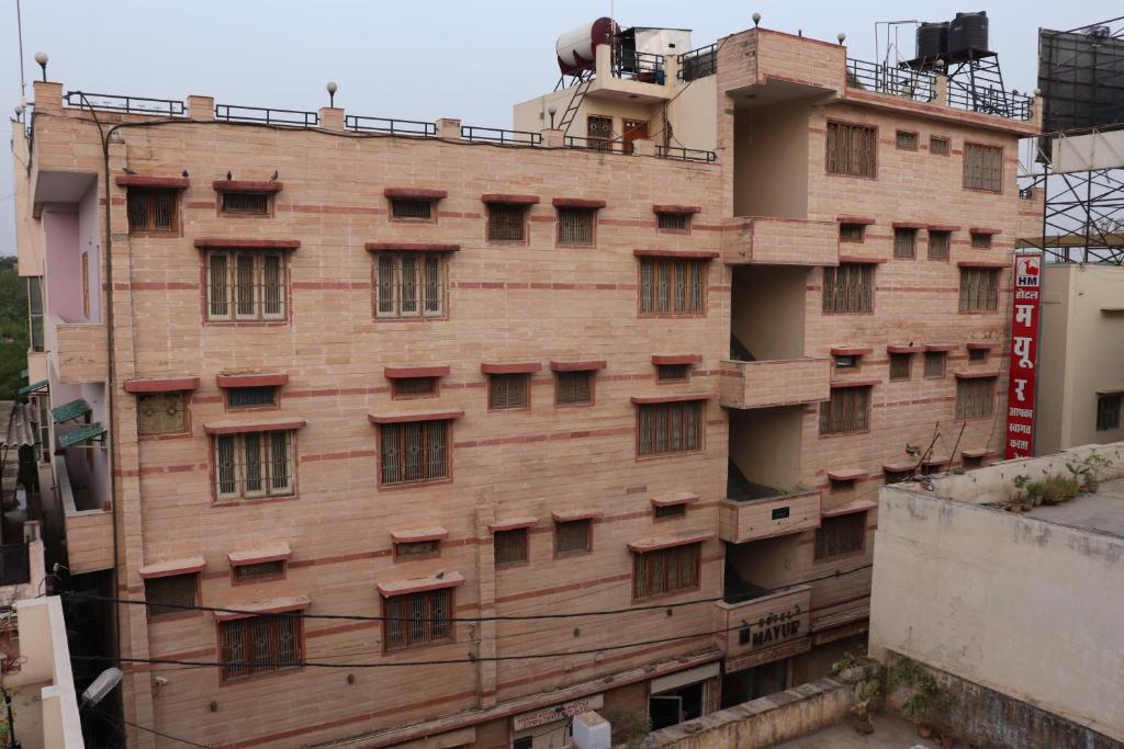 a brick building with windows on the side of it at Hotel Mayur in Gwalior