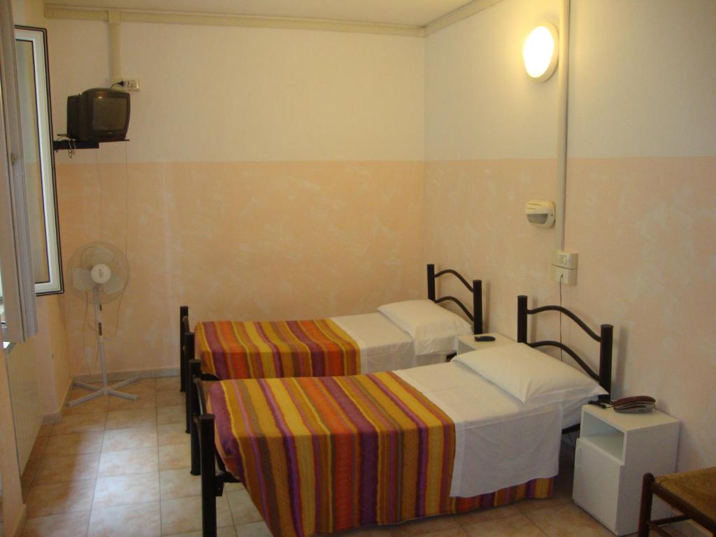 Postel nebo postele na pokoji v ubytování Albergo Gino