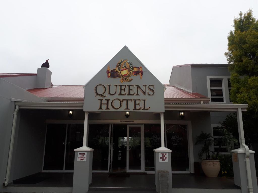 a hotel with a sign for a queens hotel at Queens Casino and Hotel in Queenstown