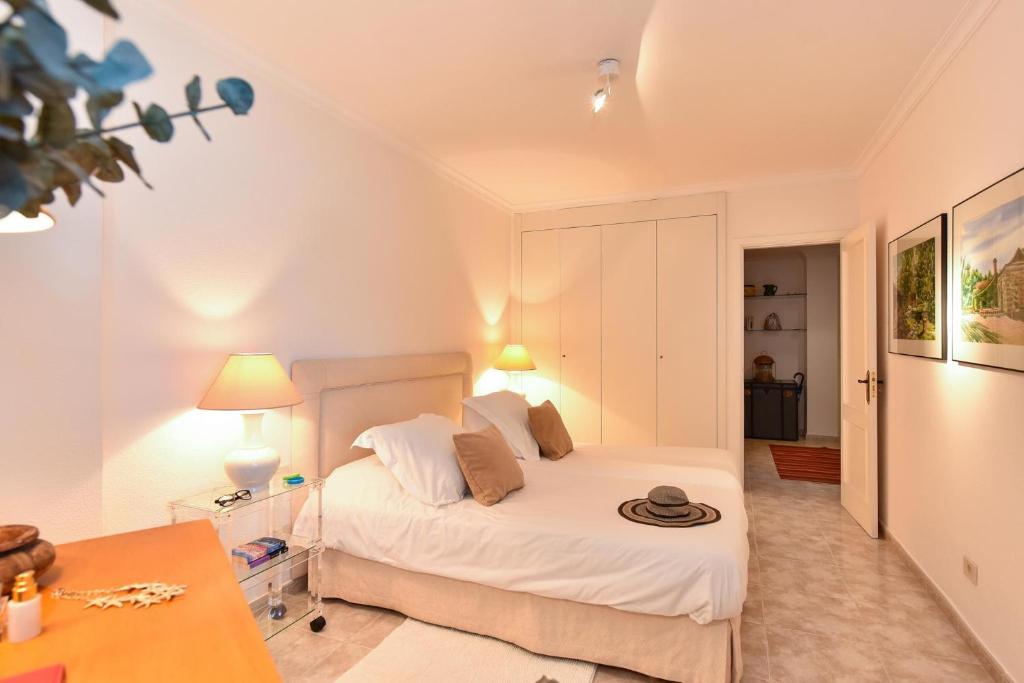 A bed or beds in a room at Las Canteras Seafront Apartment