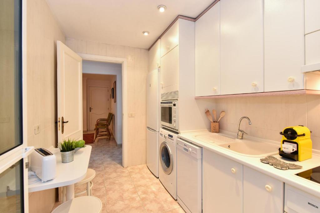 A kitchen or kitchenette at Las Canteras Seafront Apartment