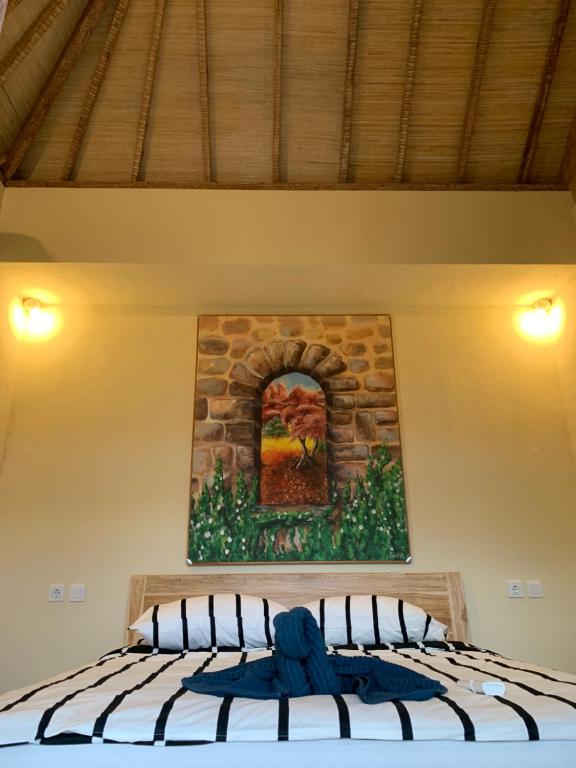Postel nebo postele na pokoji v ubytování Lazy Inn Kuta Lombok