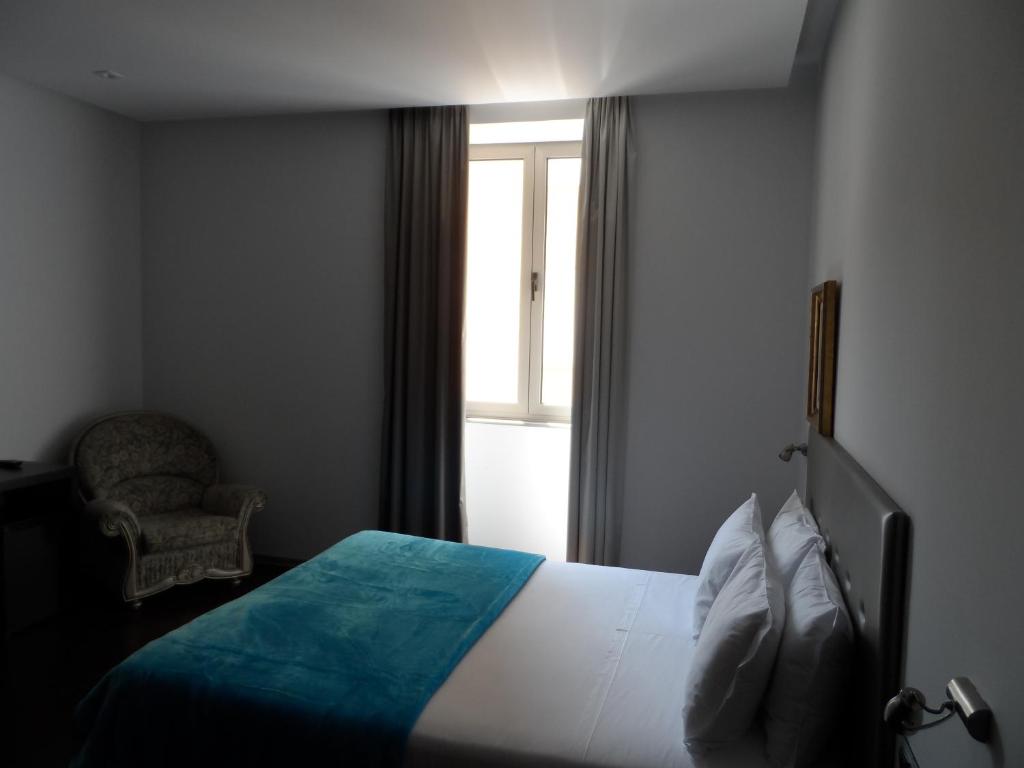 Postel nebo postele na pokoji v ubytování Lazza Hotel
