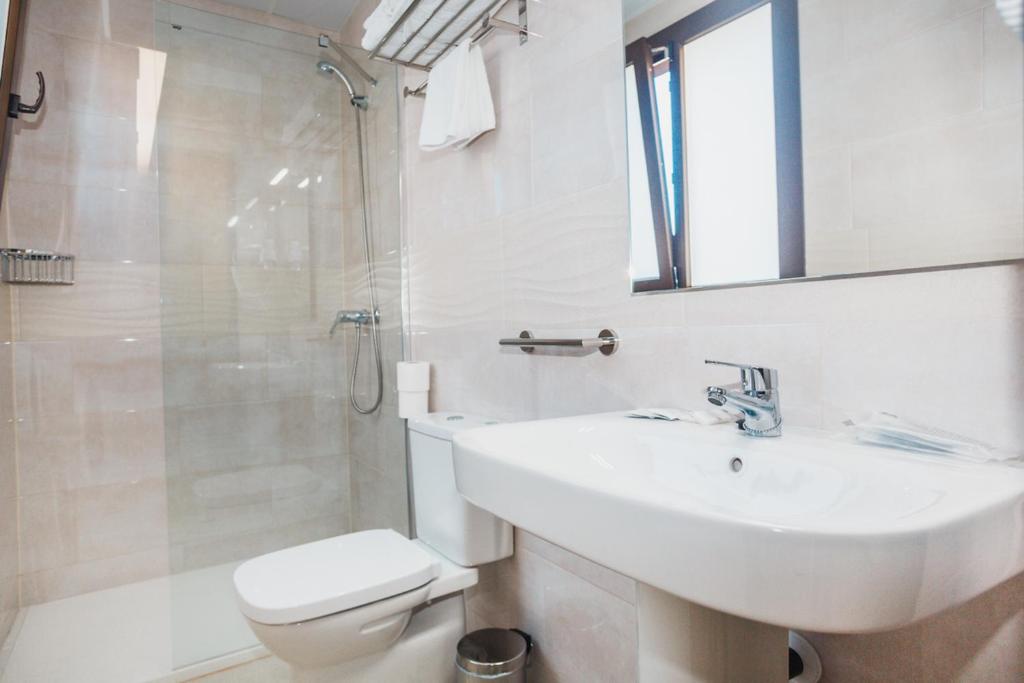 a bathroom with a sink and a toilet and a shower at Solesperit in Lloret de Mar