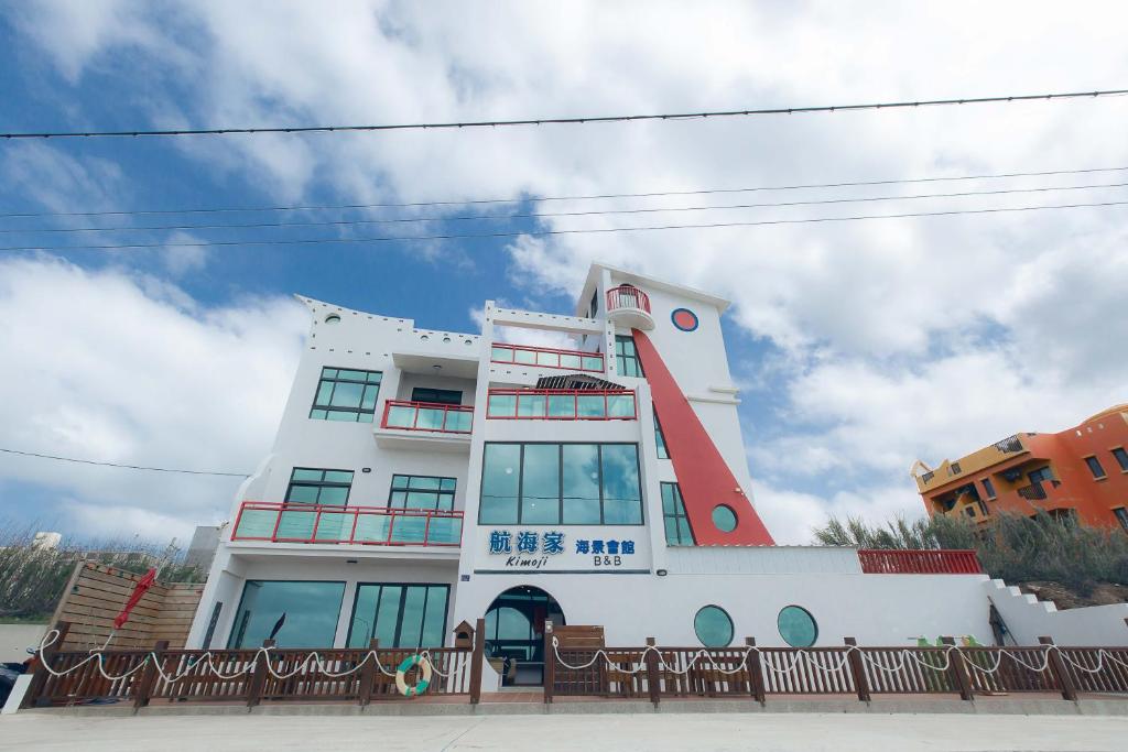 a building with a red and white at Kimoji B&B in Huxi
