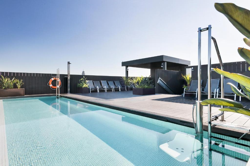 a swimming pool on the roof of a building at Andante Hotel in Barcelona