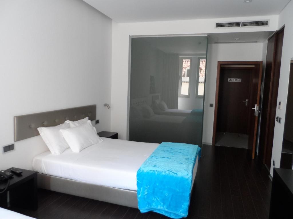 Postel nebo postele na pokoji v ubytování Lazza Hotel