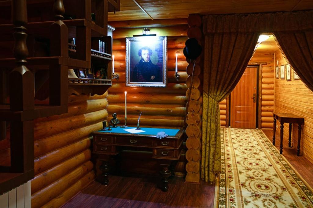 a bathroom with a sink in a log cabin at Pushkinsky Dvorik in Izhevsk