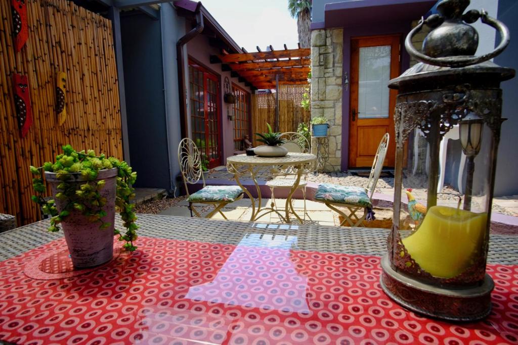 a table with a red table cloth on a patio at Milly's Touch Studios in Roodepoort