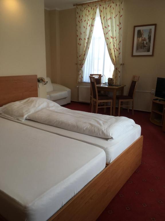 A bed or beds in a room at Hotel Roháč
