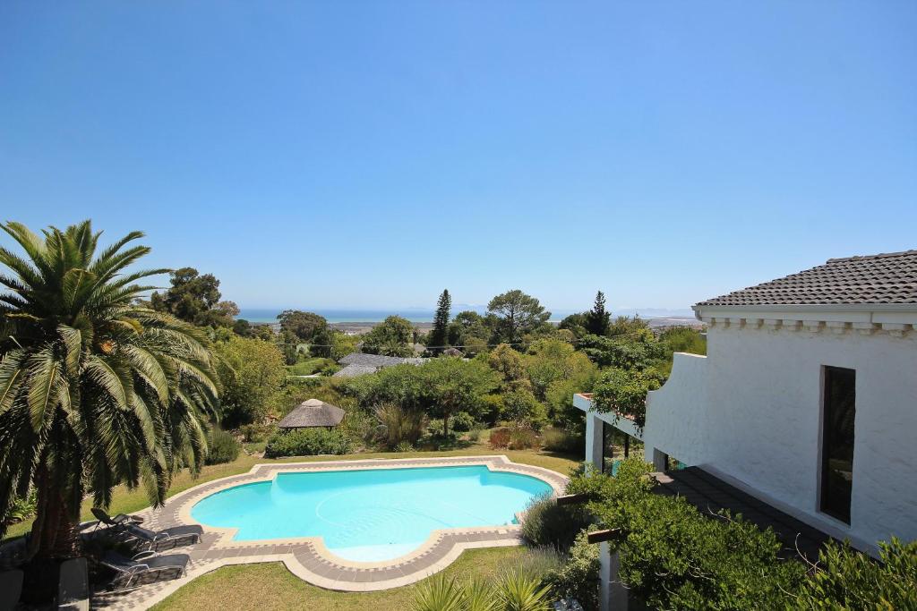 an aerial view of a swimming pool next to a house at Montrose Guesthouse in Somerset West