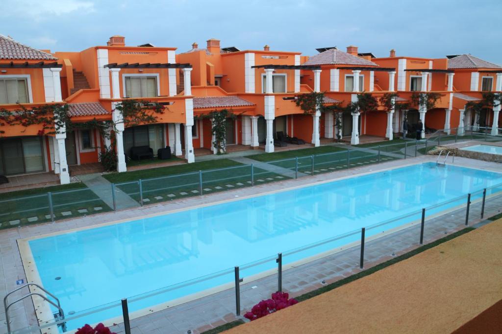 a large swimming pool in front of some houses at Delux Tavira I in Tavira