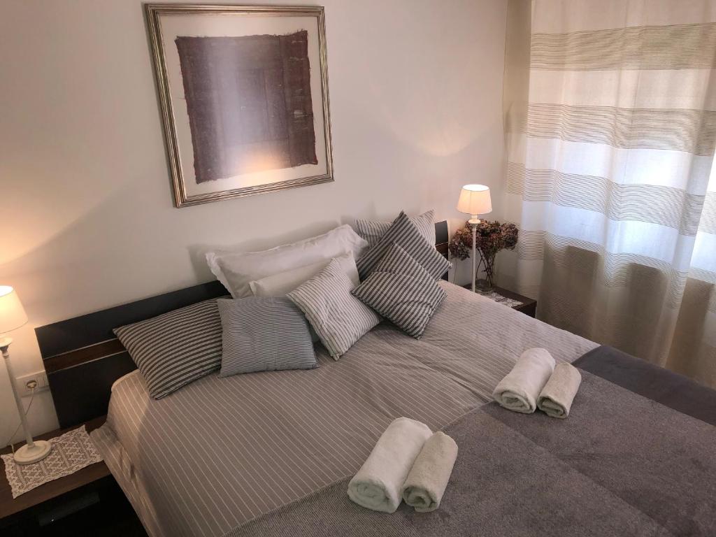 een slaapkamer met een bed met twee handdoeken erop bij Klinar - Cosy apartment with a terrace in Bled