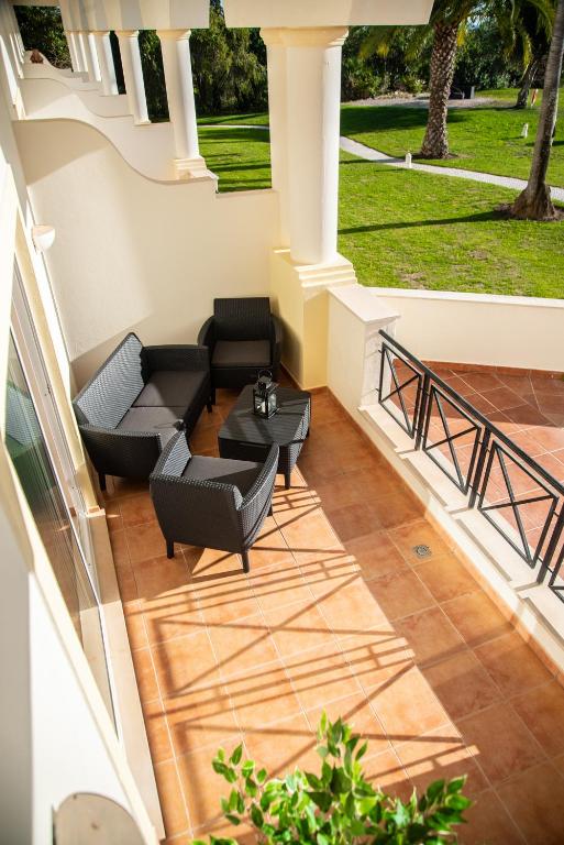 an outdoor patio with couches and a table at Colina Verde Resort in Moncarapacho