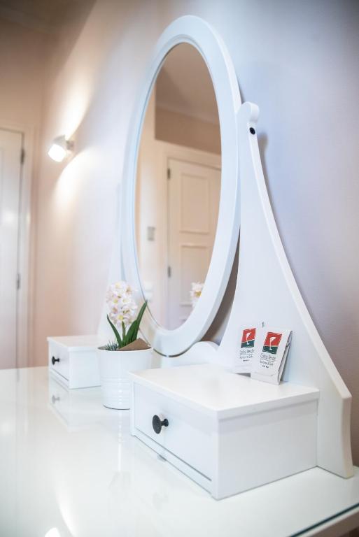 a white dressing table with a mirror on it at Colina Verde Resort in Moncarapacho