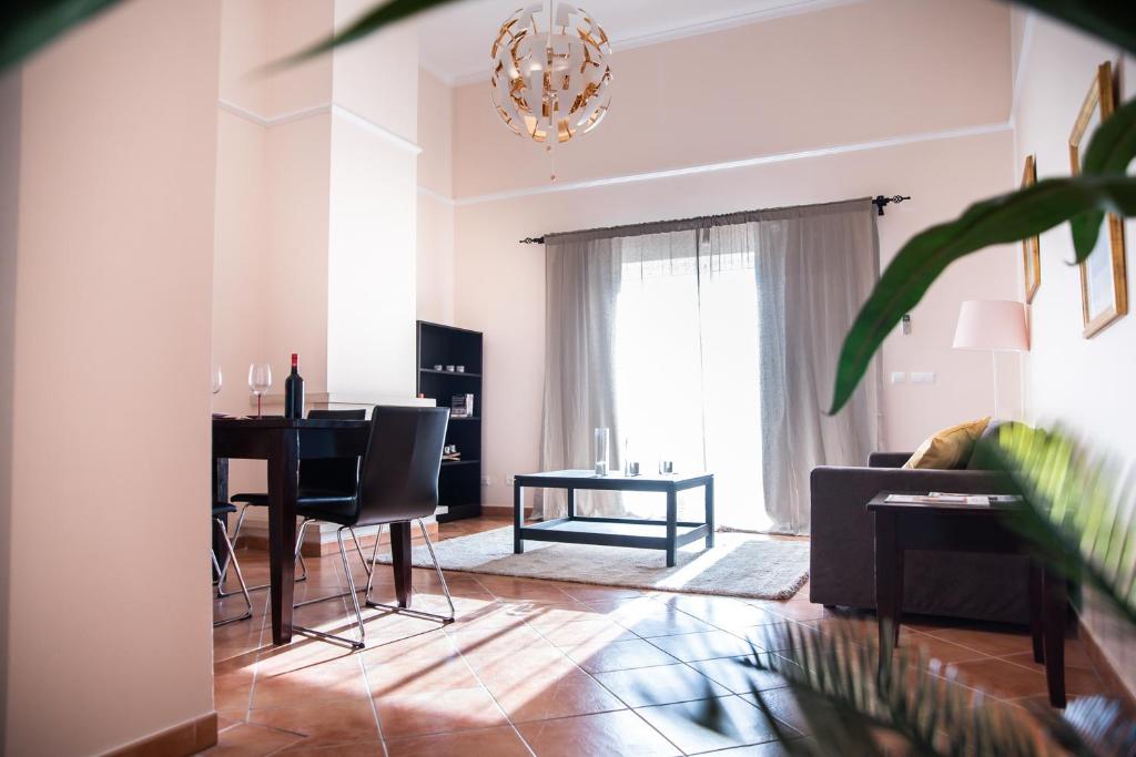 a living room with a table and a couch at Colina Verde Resort in Moncarapacho