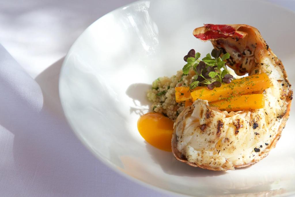 a plate of food with eggs and vegetables on it at Cobblers Cove - Barbados in Saint Peter