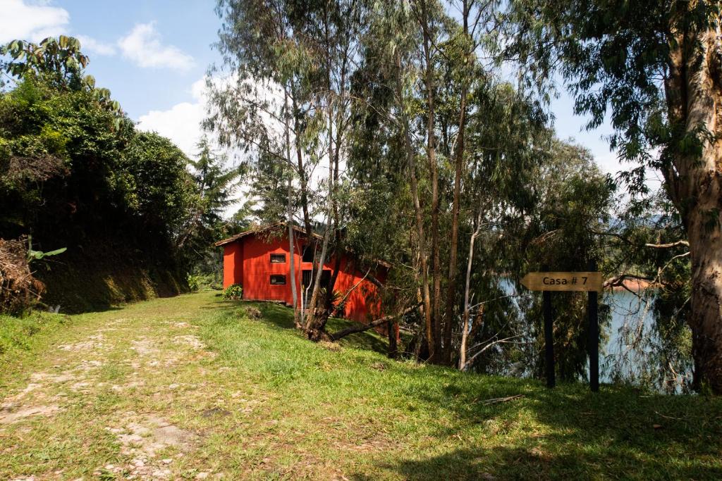 a red boat sitting in the middle of a river at Ecolodge Bahia del Peñón in Guatapé