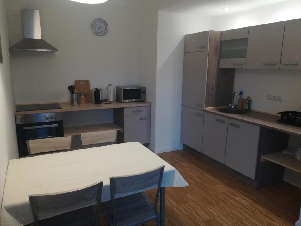 a kitchen with a table and chairs in a room at Zur Sternschnuppe in Borken