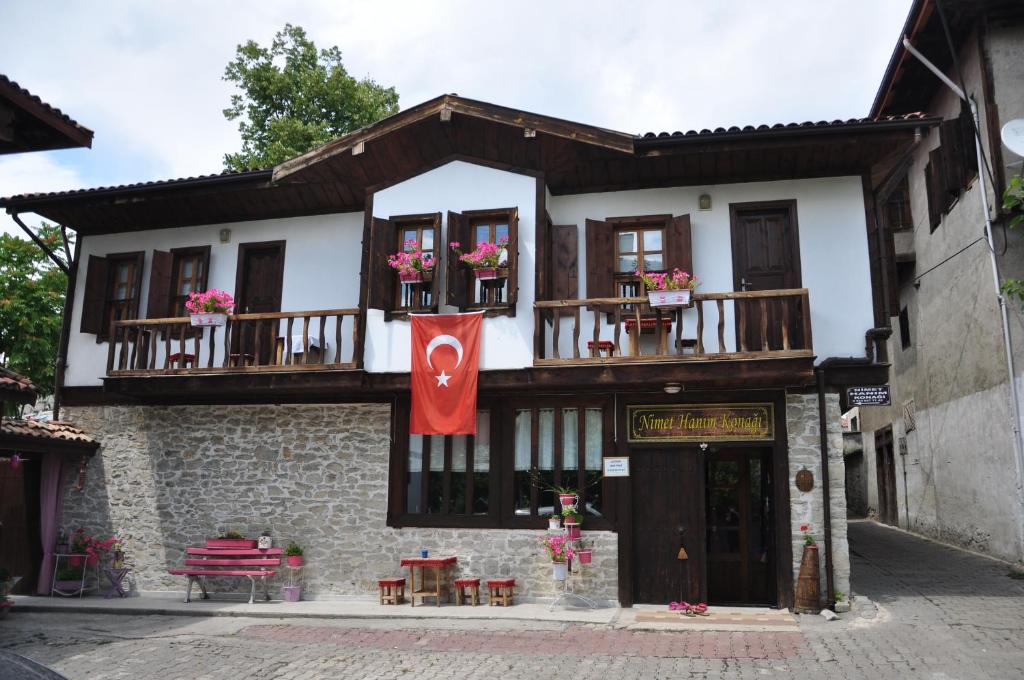 een gebouw met een vlag ervoor bij Nimet Hanım Konağı in Safranbolu