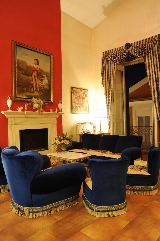 a living room with blue chairs and a fireplace at RESIDENZA D'ORIA B&B in Foggia