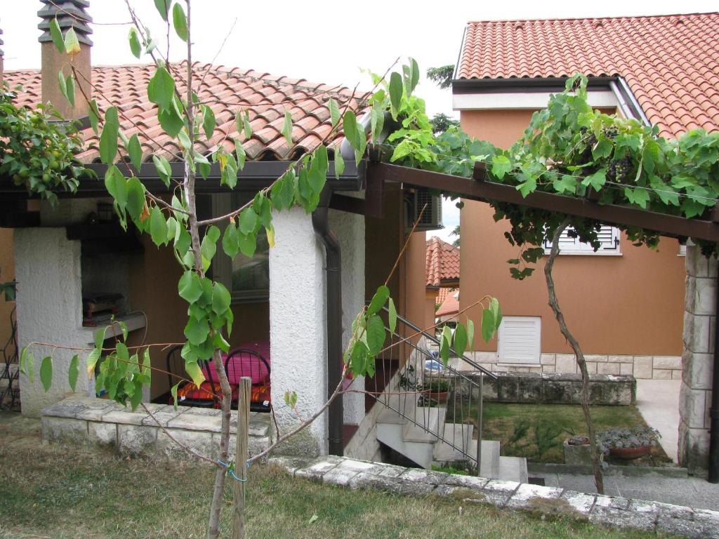 a house with a staircase in the yard at Apartma Ravbar Portorož in Portorož