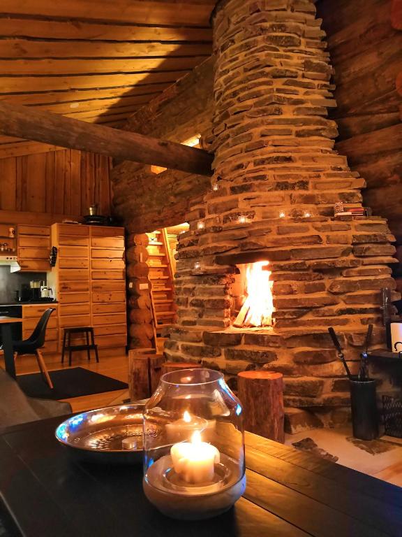 a fireplace in a room with a table with candles at Ruka Aava in Ruka