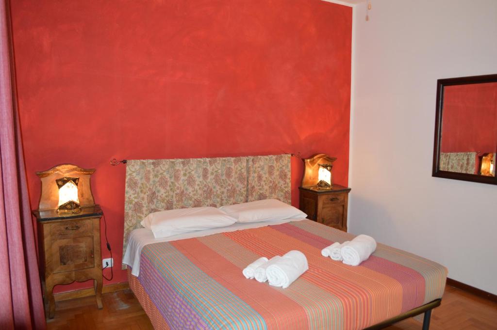 a bedroom with a bed with two towels on it at Betty's House in Mandello del Lario