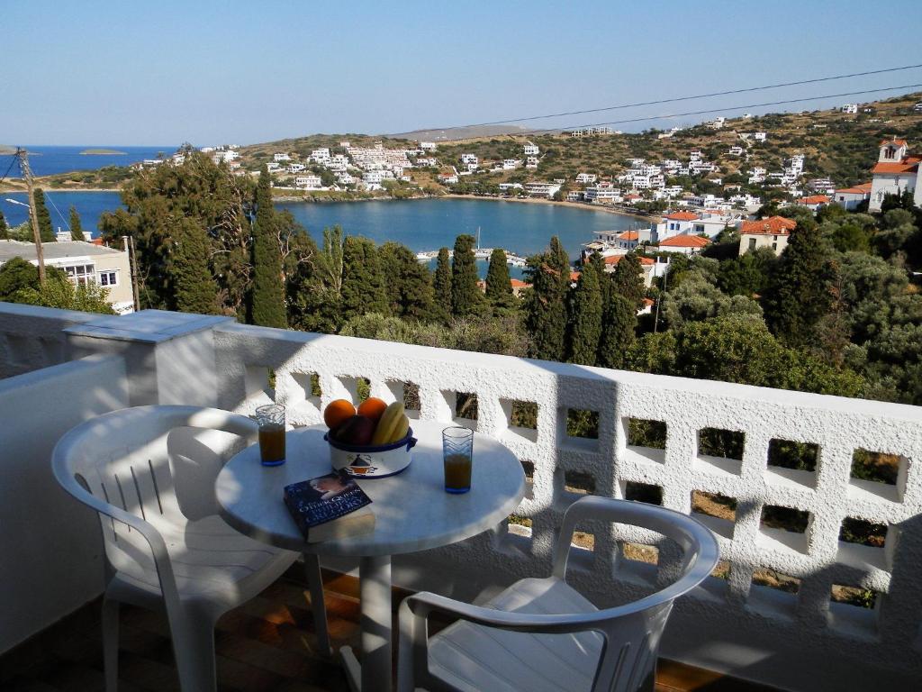 a table with a bowl of fruit on top of a balcony at Villa Dora Studios in Batsi