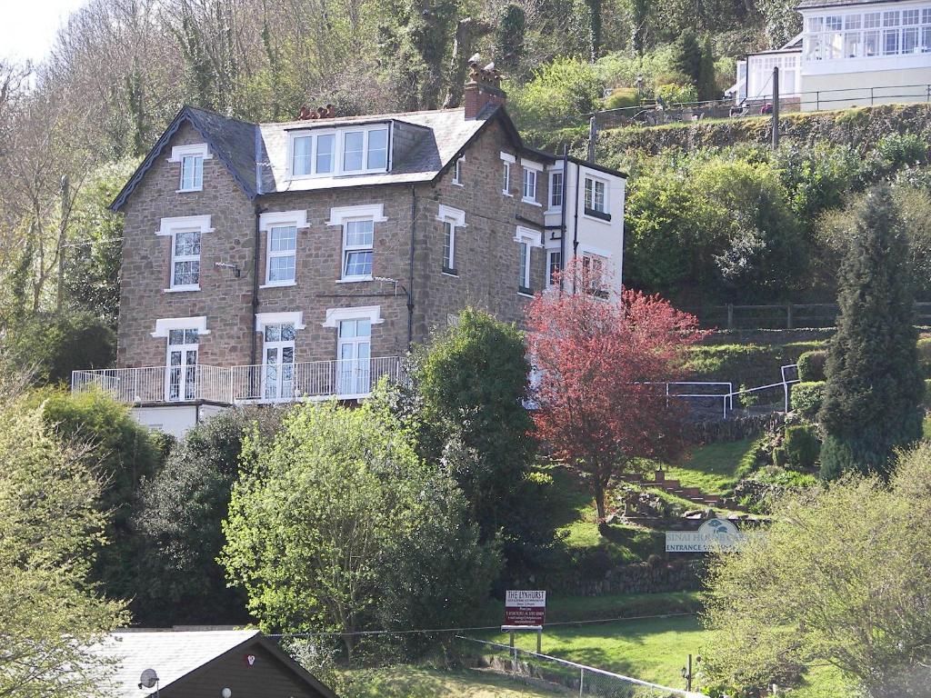 a large brick house on the side of a hill at Sinai House in Lynton