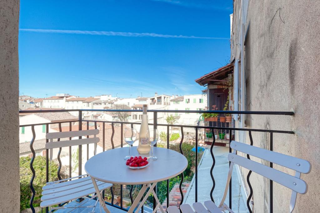 a small table on a balcony with two chairs at Vieil Antibes Charming Guillaumont in Antibes