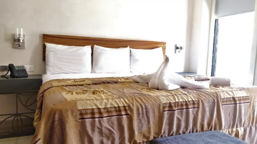 Postel nebo postele na pokoji v ubytování Hotel Urban