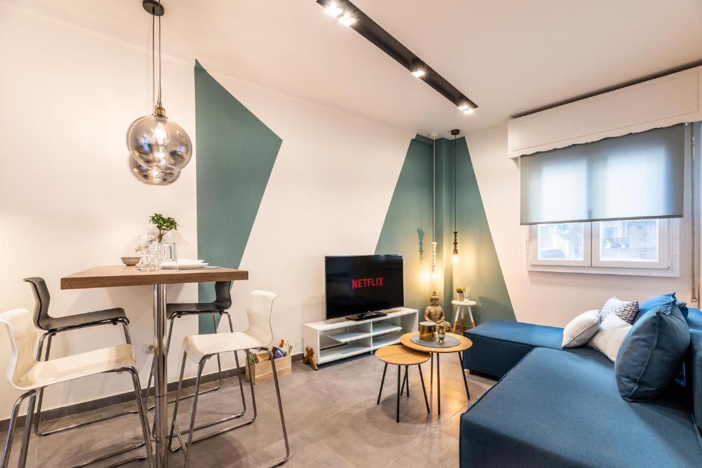 a living room with a blue couch and a table at Ports Crossroad A in Piraeus