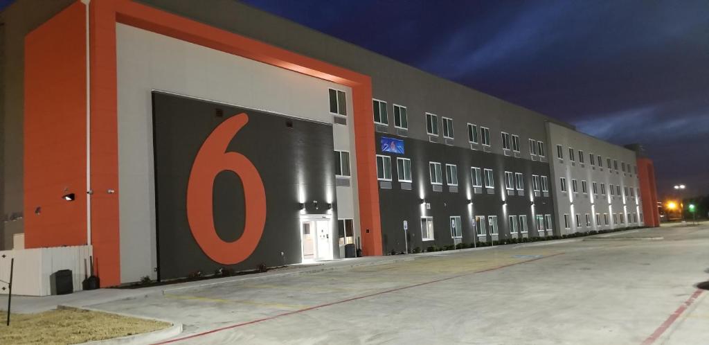 a large building with a number painted on the side at Motel 6-Corpus Christi, TX in Corpus Christi