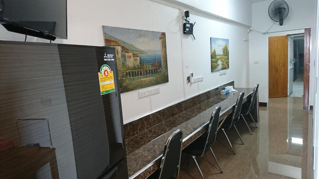 a room with chairs and paintings on the wall at 18floor condo close to MRTwith 2 bedrooms in Hua mak in Bangkok