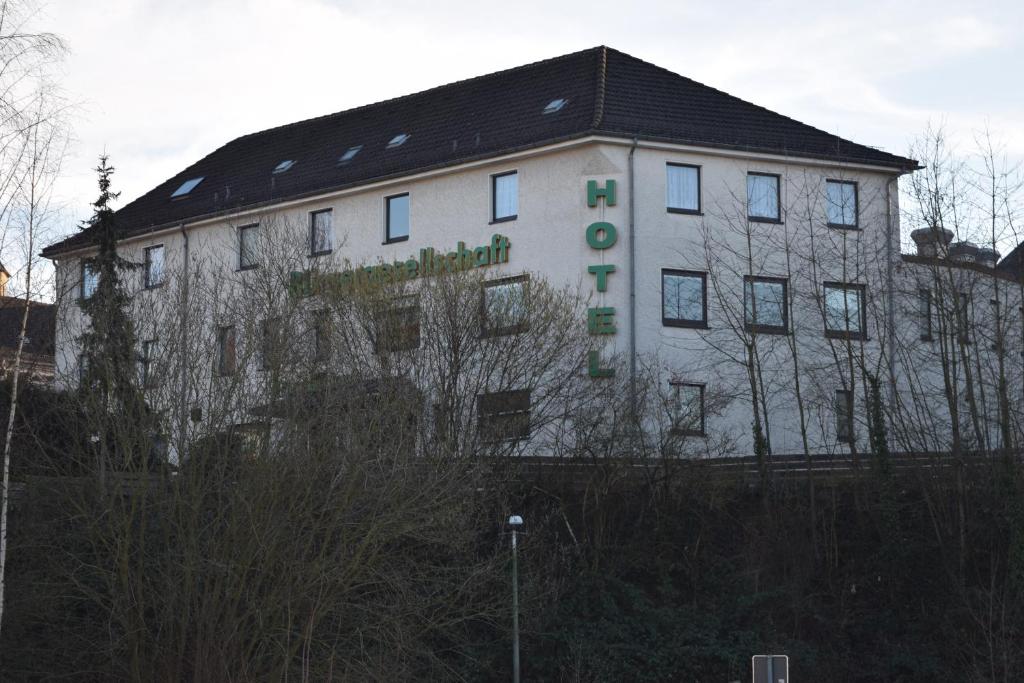 a white building with writing on the side of it at Hotel Bürgergesellschaft in Betzdorf
