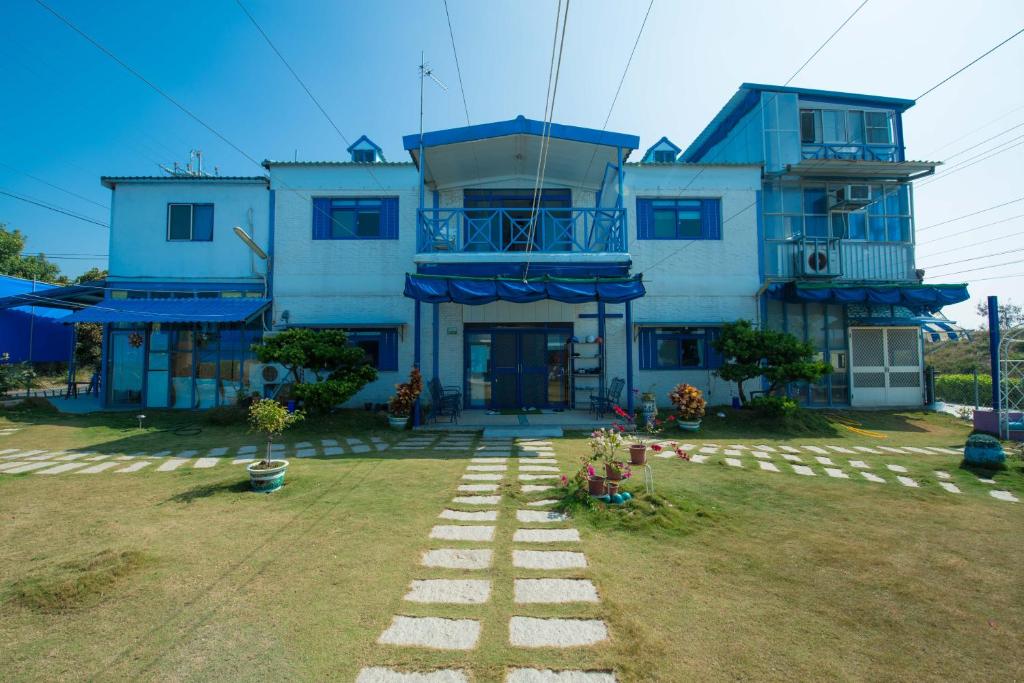 ein blaues Haus mit einem Weg davor in der Unterkunft 布袋愛琴海Aegean Sea B&B Budai in Budai