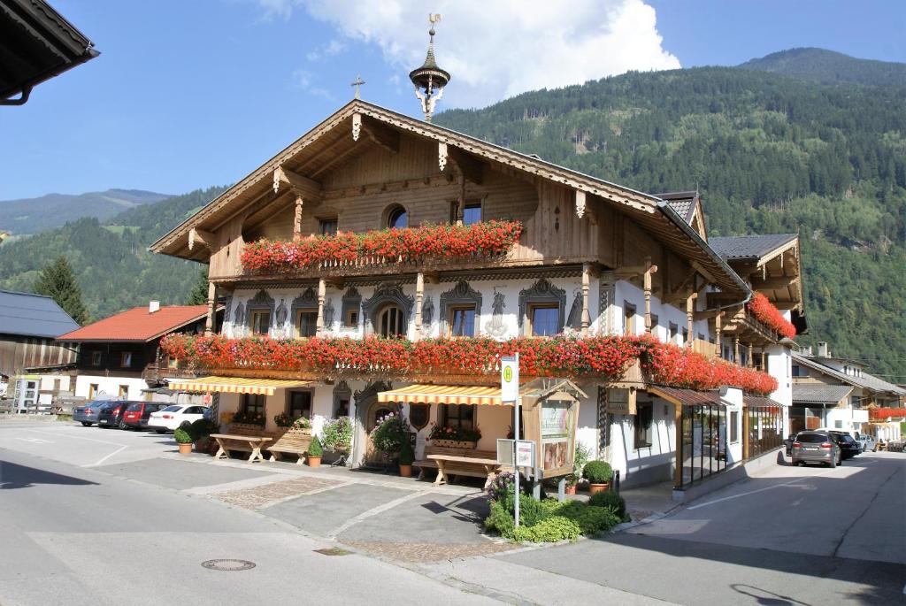 ein Gebäude mit Blumen auf der Seite in der Unterkunft All Inclusive Hotel Bachmayerhof in Uderns