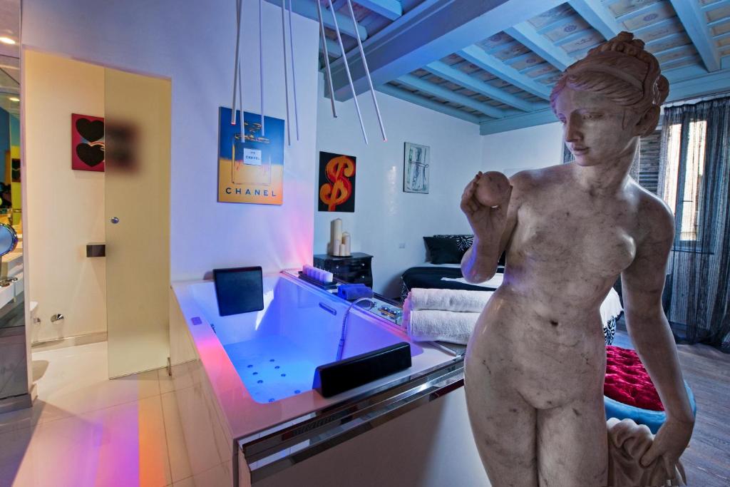 a statue of a boy in a living room at Pantheon Relais Luxury in Rome