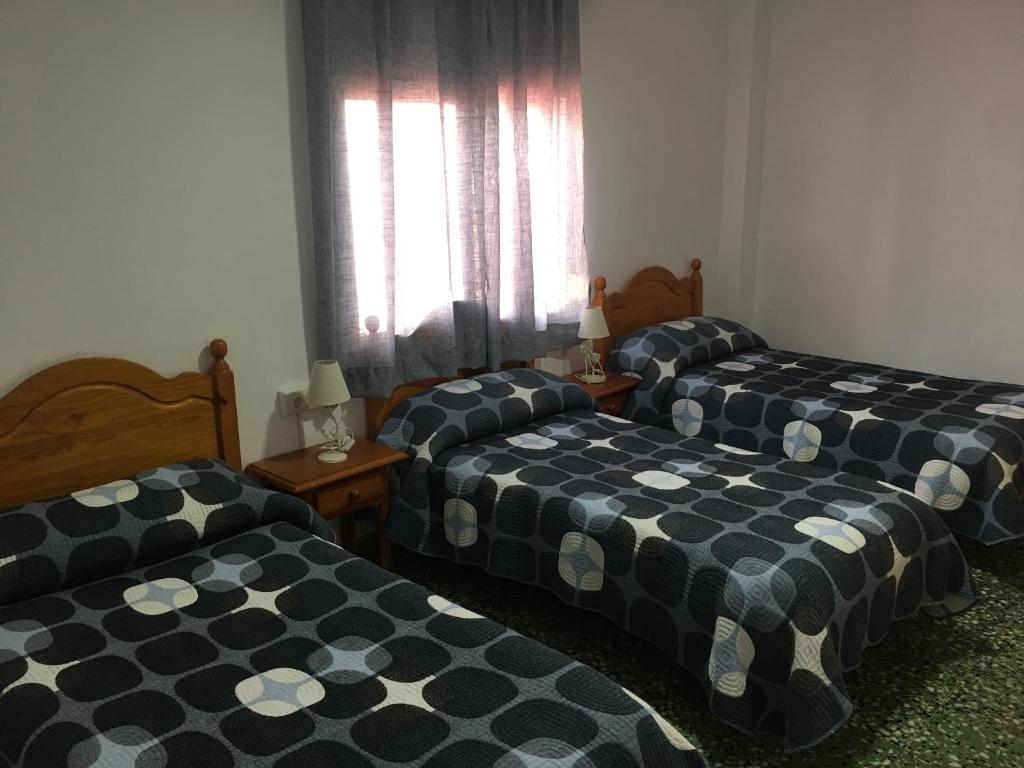 Postel nebo postele na pokoji v ubytování Hostal Gutierrez