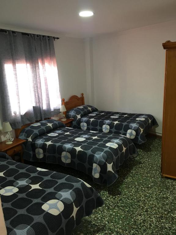 Postel nebo postele na pokoji v ubytování Hostal Gutierrez