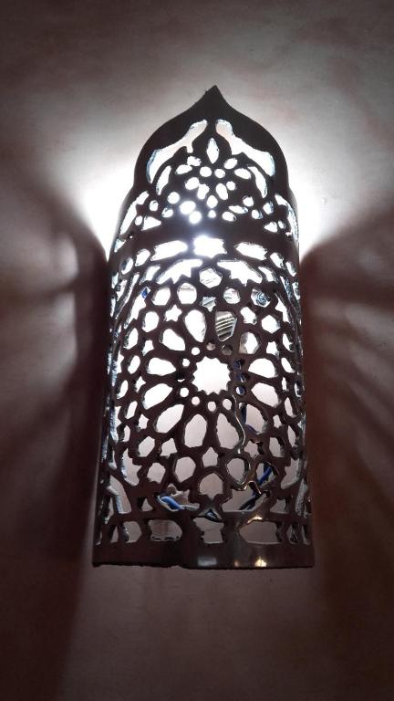 a black and white lamp sitting on a couch at Hotel AMOUDOU فندق أمودو in Tiznit