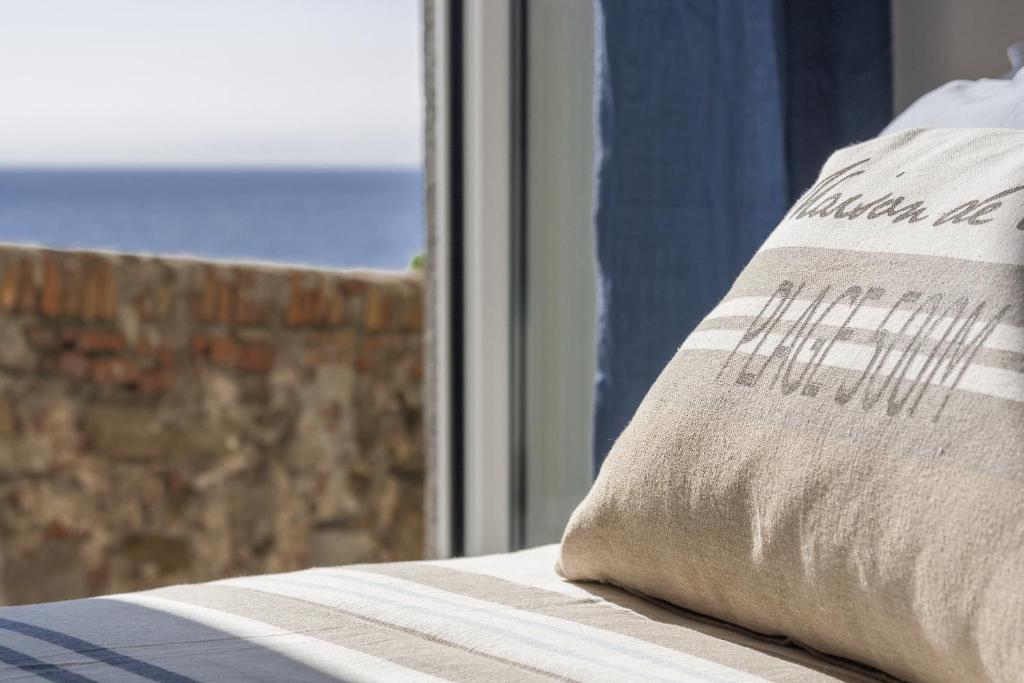 a pillow sitting on a bed in front of a window at Miramare love nest 5terreparco in Riomaggiore