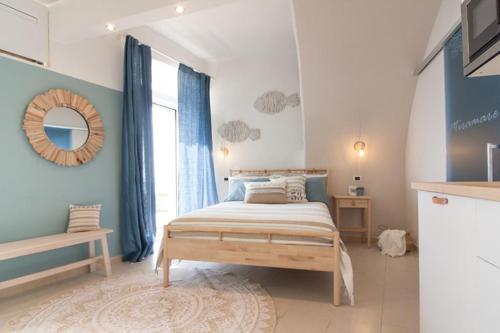 a bedroom with a bed and a large window at Miramare love nest 5terreparco in Riomaggiore