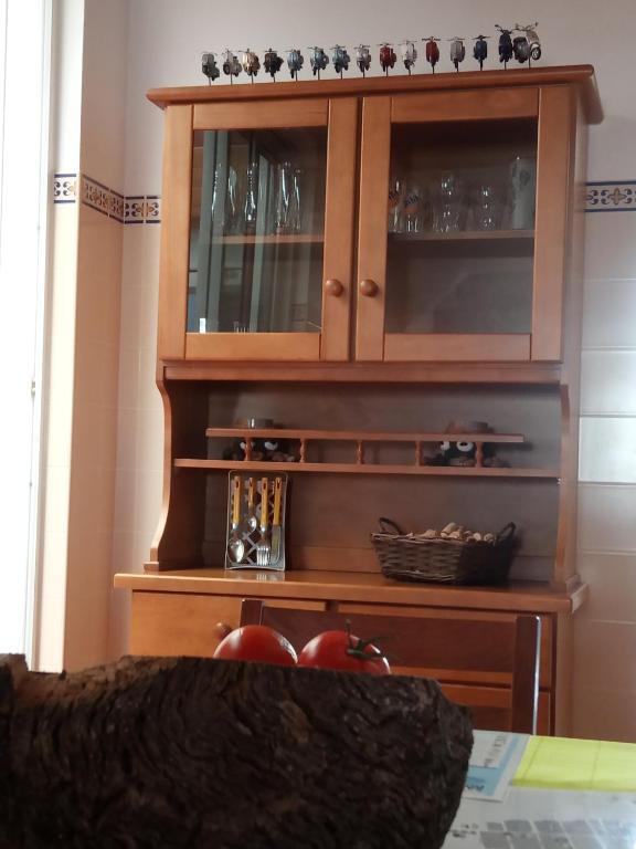 a wooden hutch with glasses in it at Hostel Nature in Zambujeira do Mar