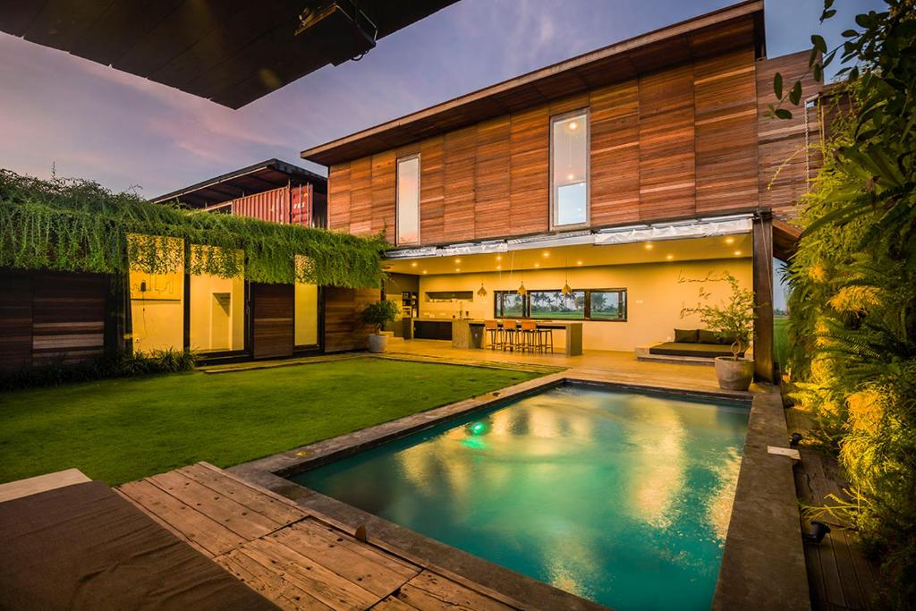 a swimming pool in the backyard of a house at Kontiki Villa - Joshua District in Tabanan