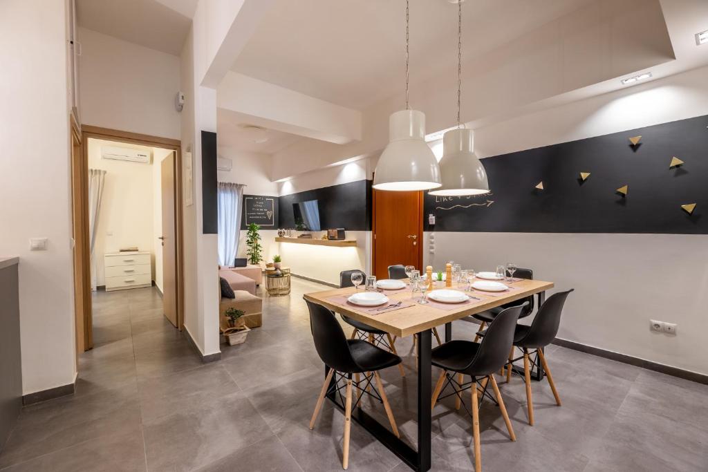a dining room and living room with a table and chairs at Ports Crossroad D in Piraeus