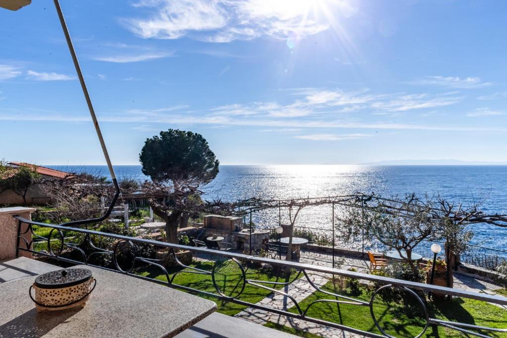 a view of the ocean from the balcony of a house at Dimitra's Studios in Stoupa