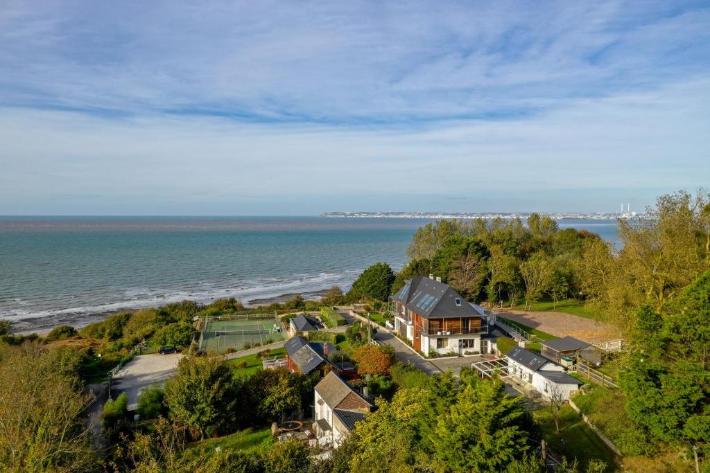 an aerial view of a house next to the ocean at Domaine du Grand Bec in Villerville