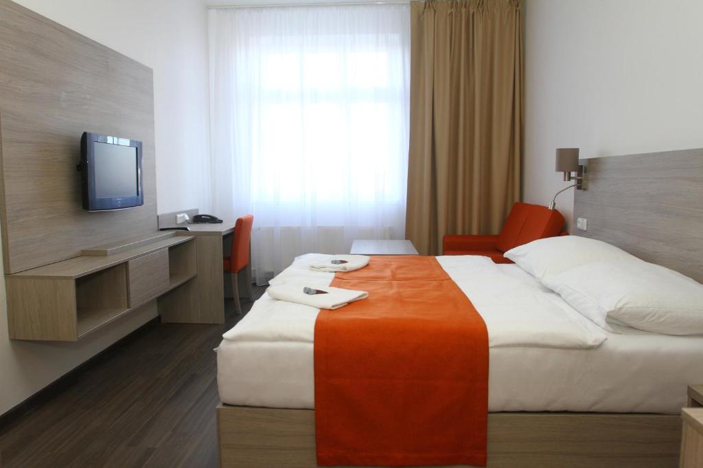 Postel nebo postele na pokoji v ubytování Hotel Palác Elektra